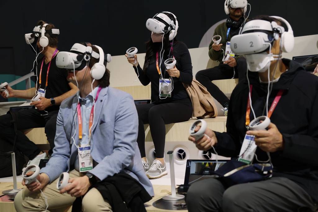 Attendees try out the Caliverse Hyper-Realistic Metaverse experience at the Lotte booth at CES 2023 at the Las Vegas Convention Center on Jan. 5, 2023, in Las Vegas, Nevada
