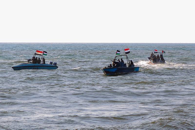 Members of the Yemeni Coast Guard, affiliated with the Houthi group, patrol the sea as demonstrators march through the Red Sea port city of Hodeida in solidarity with the people of Gaza on Jan. 4, 2024.
