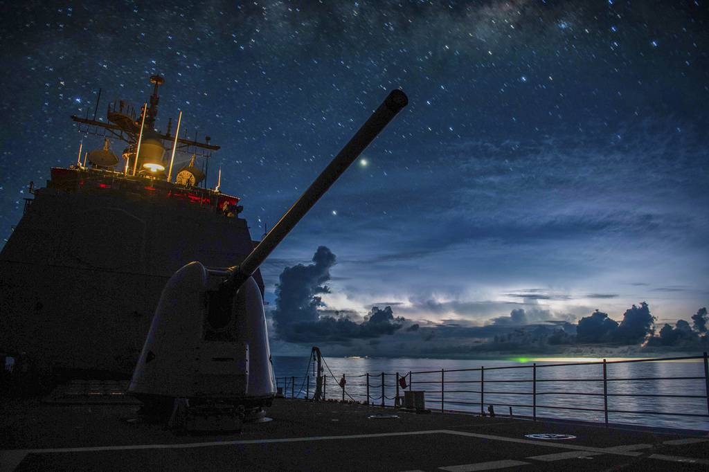 The Ticonderoga-class guided-missile cruiser USS Princeton (CG 59) steams through the night in the South China Sea on July 15, 2020.