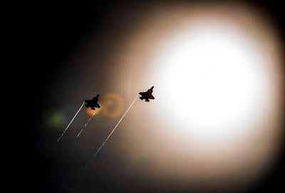 A pair of F-35 Lightning IIs pass under the sun near Eglin Air Force Base, Florida.