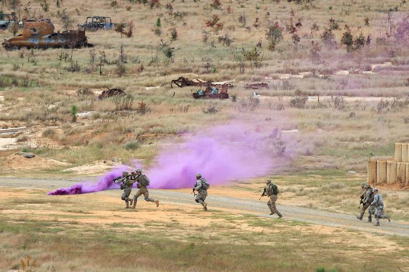 Paratroopers assigned to the 82nd Airborne Division move through smoke toward an objective during rehearsals for a live-fire exercise on Fort Bragg, North Carolina, in 2015.