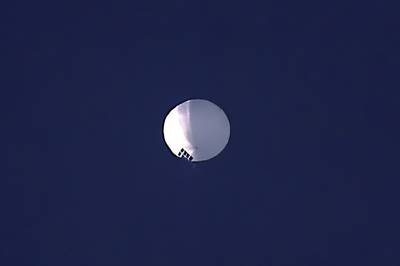 A high altitude balloon floats over Billings, Mont., on Wednesday, Feb. 1, 2023. The huge, high-altitude Chinese balloon sailed across the U.S. on Friday, drawing severe Pentagon accusations of spying and sending  excited or alarmed Americans outside with binoculars.