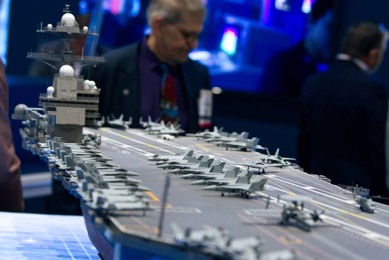 A model aircraft carrier is displayed at defense contractor HII's booth at the West conference in San Diego.