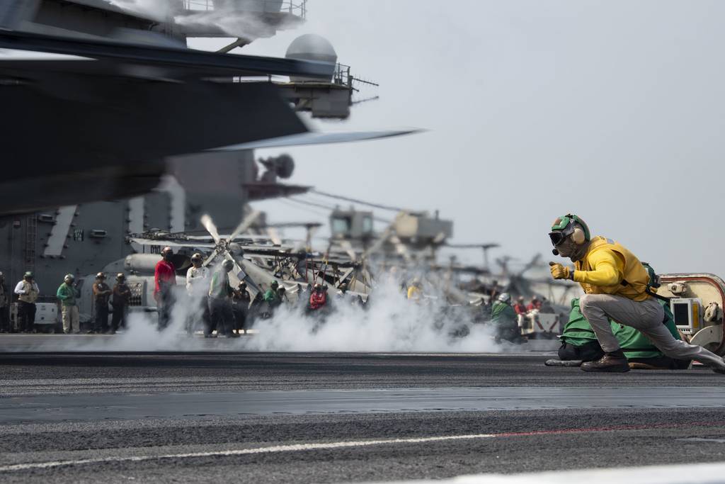 Lt. Cmdr. Justin Felgar signals an F/A-18F Super Hornet to launch from the flight deck of the aircraft carrier USS Ronald Reagan (CVN 76) on Aug. 4, 2020, in the Pacific Ocean.