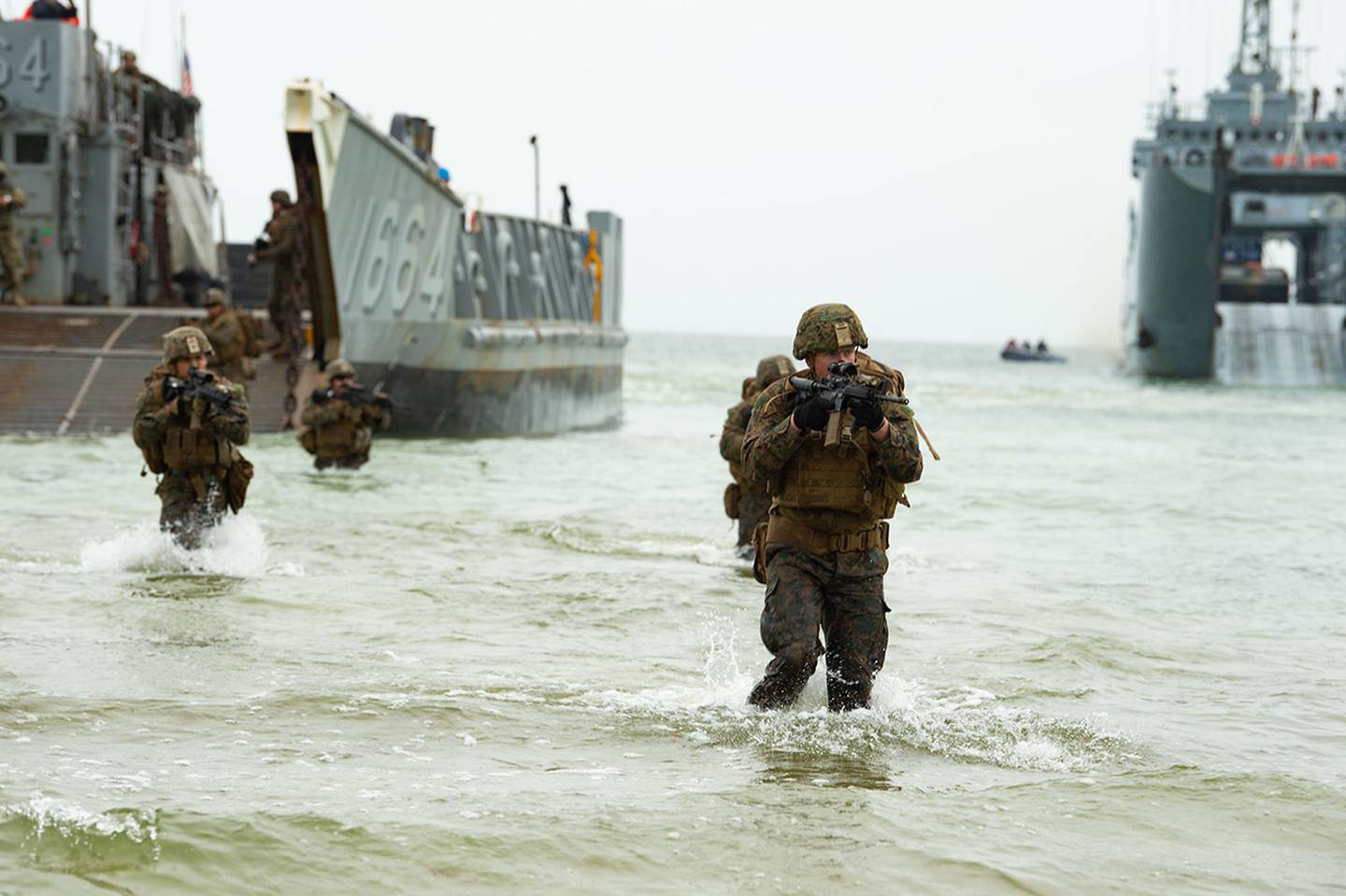 U.S. Marines wade ashore from a landing craft, utility on June 16, 2019, during an amphibious assault for exercise Baltic Operations (BALTOPS) 2019 in Klaipeda, Lithuania.
