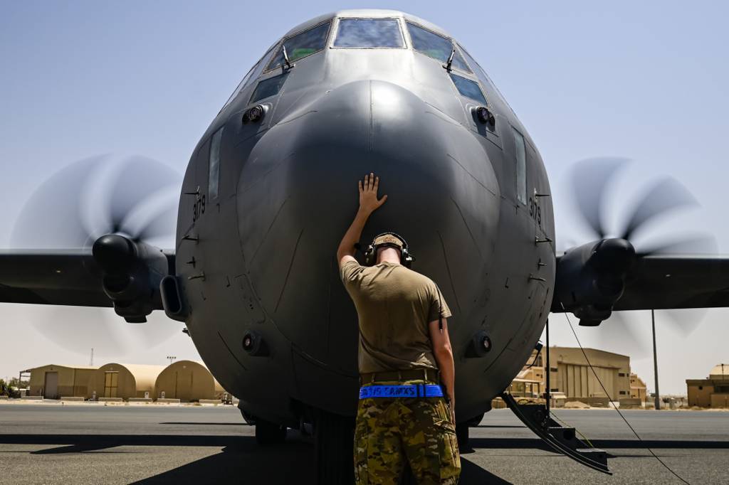 A U.S. Air Force flying crew chief assigned to the 40th Expeditionary Airlift Squadron touches the nose of a C-130J Super Hercules aircraft for good luck prior to boarding the aircraft for a mission supporting the Combined Joint Task Force - Operation Inherent Resolve, in U.S. Central Command on July 20, 2021. (Senior Airman Brennen Lege/Air Force photo)