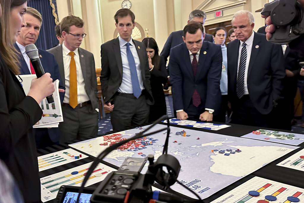 Lawmakers in a new House select committee on China gather for a tabletop war game exercise in the House Ways and Means Committee room on Wednesday, April 19, 2023, in Washington.