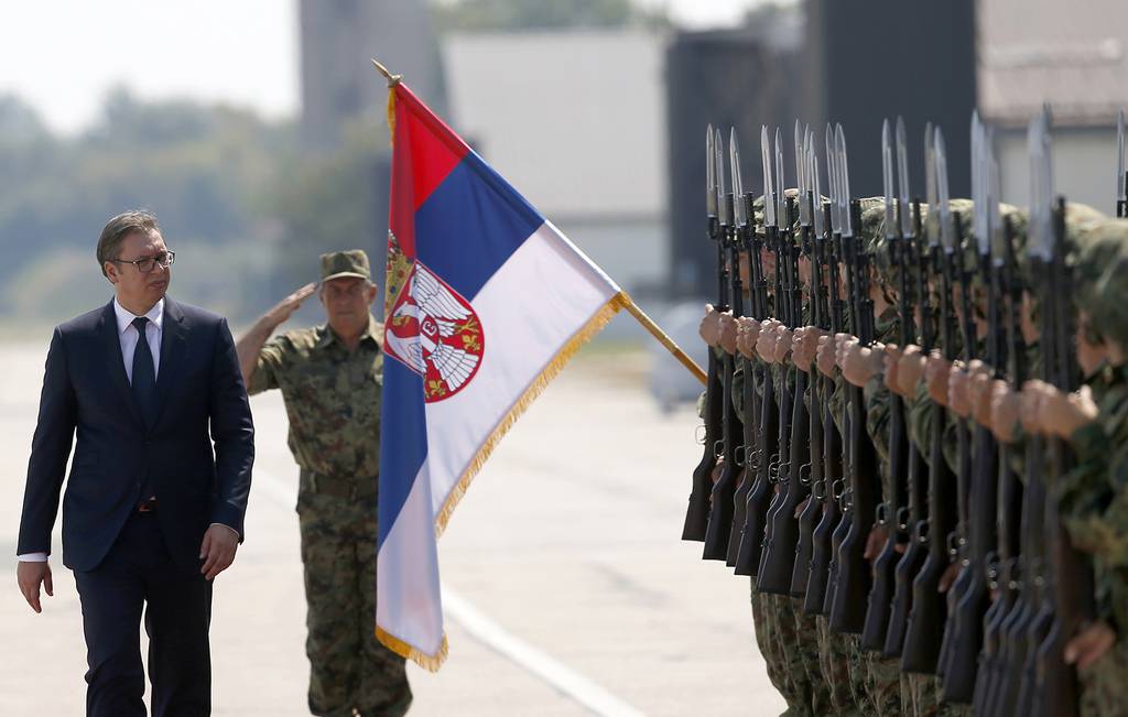 In this Aug. 21, 2018, file photo, Serbian President Aleksandar Vucic, left, reviews an honor guard on the tarmac at Batajnica, military airport near Belgrade, Serbia.
