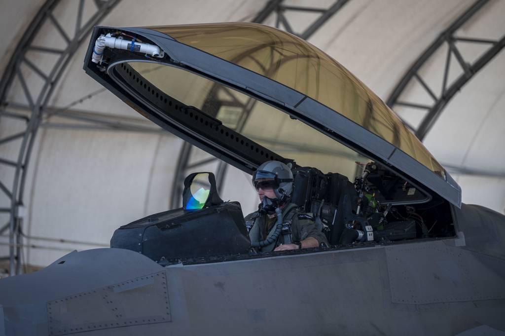 A U.S. Air Force instructor pilot assigned to the 43rd Fighter Squadron, conducts F-22 Raptor start-up procedures at Eglin Air Force Base, Florida, Feb. 1, 2022. Since the Raptor is a single-seat aircraft, instructor pilots fly alongside students during aerial missions after the student has become proficient in a simulator. The Air Force altered the photo for security purposes by blurring out identification patches. (Airman 1st Class Tiffany Price/Air Force)