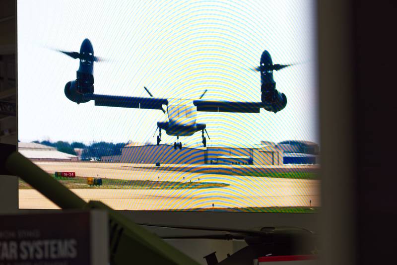 The Bell V-280 Valor is seen in a video playing above the Bell booth at the 2023 Association of the U.S. Army convention in Washington, D.C.