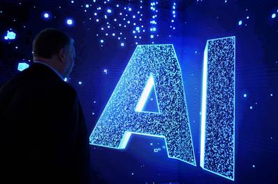 A man looks at an artificial intelligence sign on an animated screen at the Mobile World Congress conference in Spain.