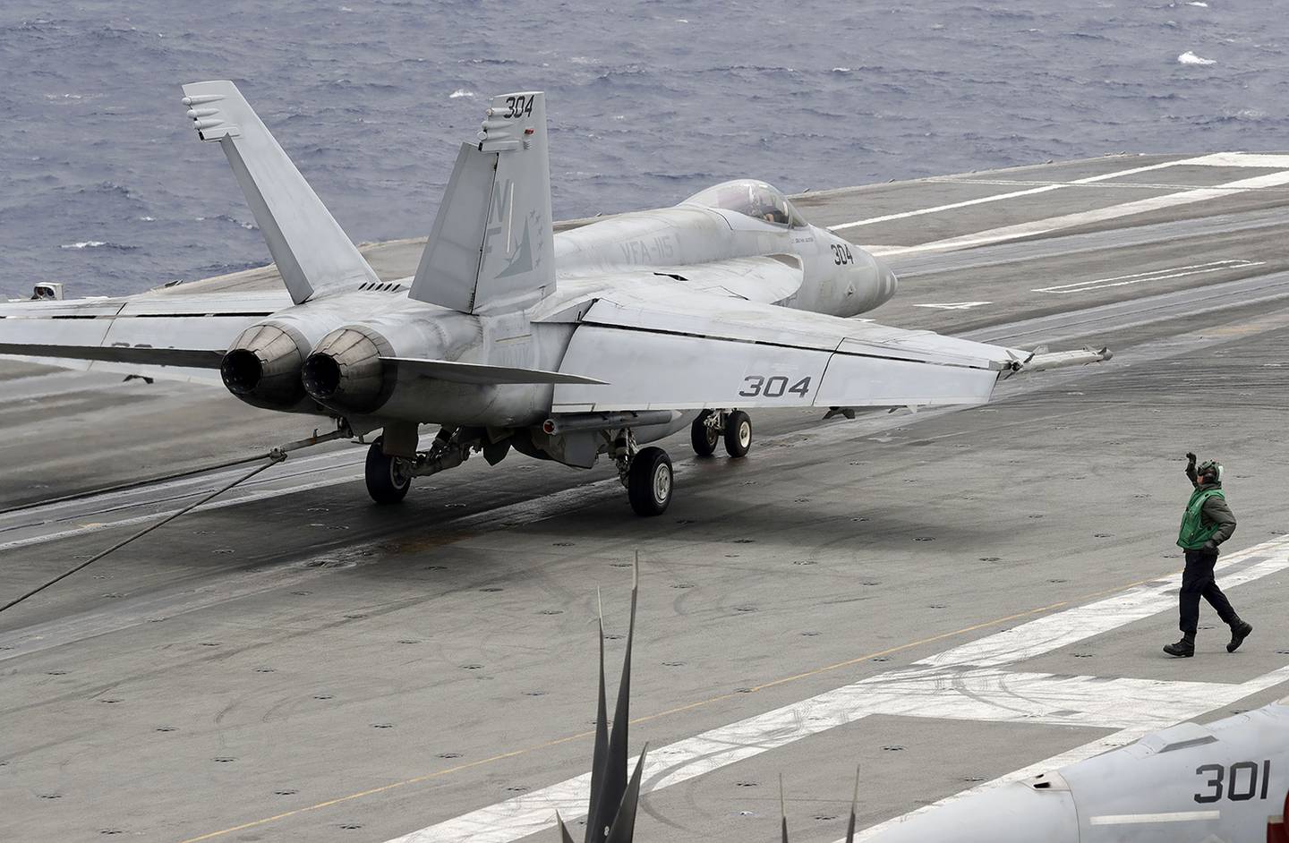 A U.S. fighter jet lands on the U.S. aircraft carrier USS Ronald Reagan following their patrol at the international waters off South China Sea Tuesday, Aug. 6, 2019.