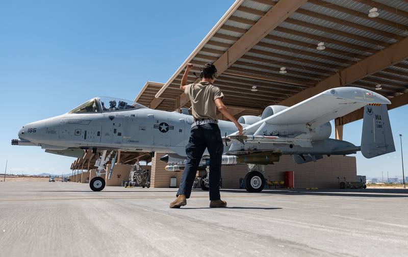 A maintainer with the 757th Aircraft Maintenance Squadron marshals an A-10 Thunderbolt II in the Gunsmoke gunnery competition at Nellis Air Force Base, May 18, 2021. (William R. Lewis/Air Force)
