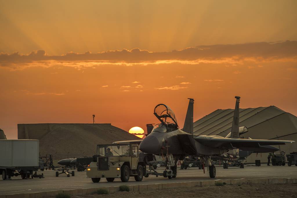 Airmen assigned to the 332nd Air Expeditionary Wing tow an F-15E Strike Eagle on April 15, 2020, at an undisclosed location in Southwest Asia.