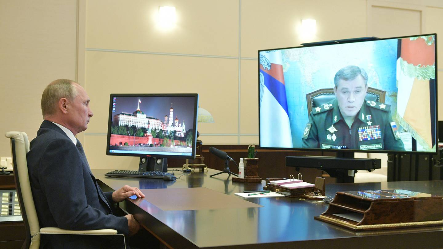 Russian President Vladimir Putin listens to General Staff chief Valery Gerasimov during a video conference at the Novo-Ogaryovo residence outside Moscow on Oct. 7, 2020.