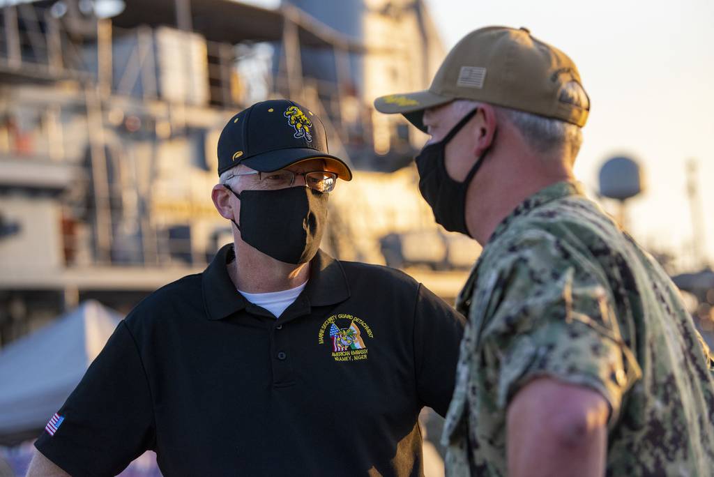 Acting Defense Secretary Christopher C. Miller meets with Navy Capt. Christopher Gilbertson, the commander of Task Force 55, during a visit to Naval Support Activity, Bahrain, Nov. 25, 2020.