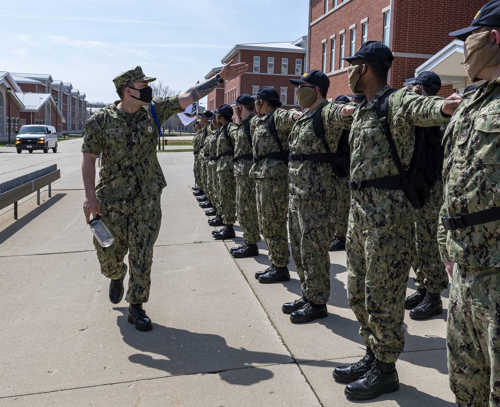 Recruits dress off in formation on the USS Chicago recruit barracks grinder on April 11, 2020, at Recruit Training Command in Great Lakes, Ill.