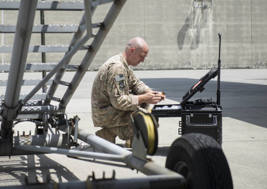 U.S. Air Force Tech. Sgt. Joshua Dungan prepares to work on an electronic warfare system at Kadena Air Base, Japan, in April 2018.