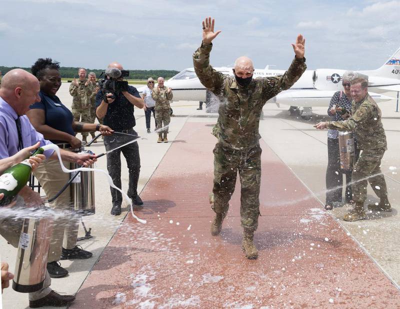 Gen. Arnold W. Bunch, Jr., Air Force Materiel Command commander, is hosed down, June 8, 2022, after his final flight at Wright-Patterson Air Force Base, Ohio. The "fini-flight" is an Air Force tradition where family, friends and coworkers hose down an aviator after their last flight in the service. (R.J. Oriez/Air Force)