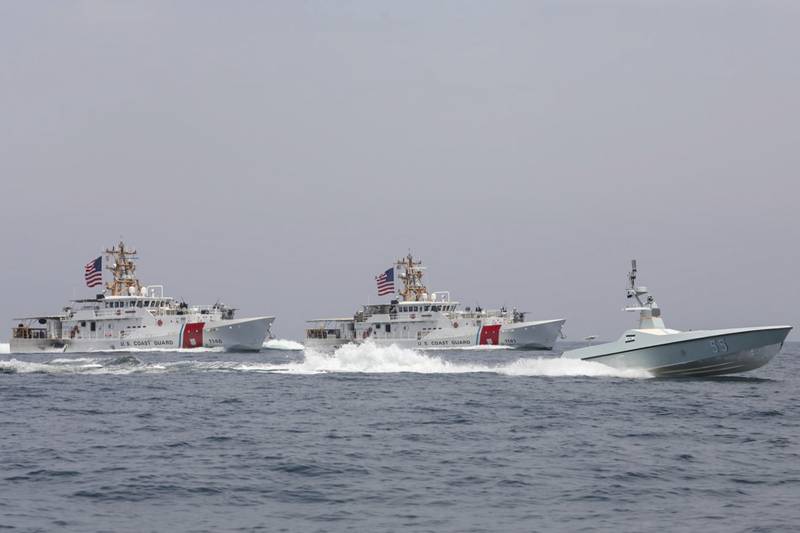 A U.S. Navy L3 Harris Arabian Fox MAST-13 drone boat and the U.S. Coast Guard cutters USCGC John Scheuerman and USCGC Charles Moulthrope transit the Strait of Hormuz on Wednesday, April 19, 2023.
