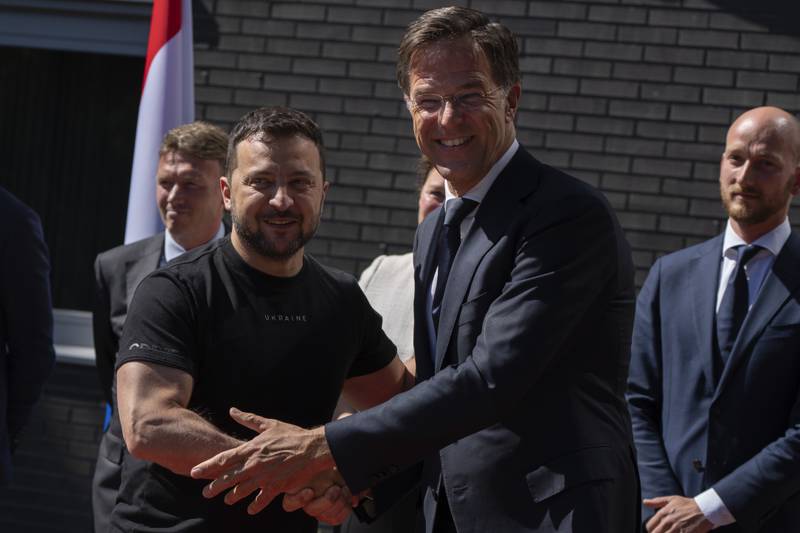 Ukrainian President Volodymyr Zelenskyy, left, is greeted by Dutch caretaker Prime Minister Mark Rutte in Eindhoven, Netherlands, Sunday, Aug. 20, 2023.