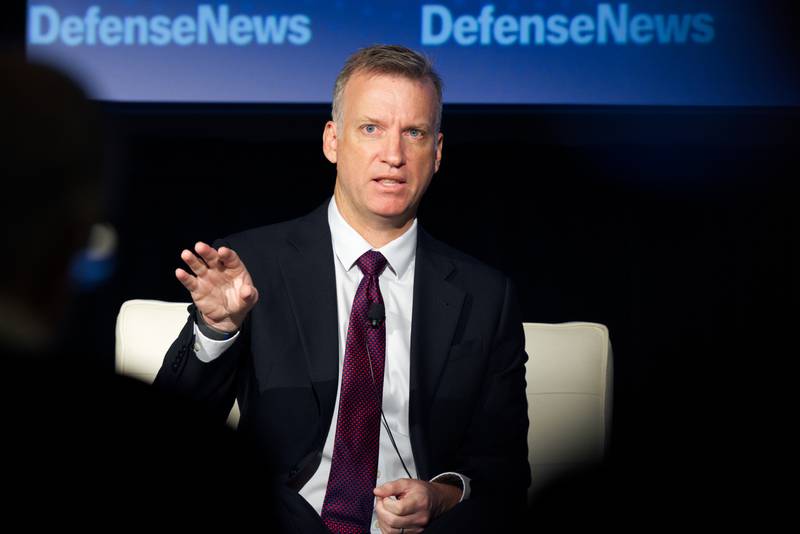 Undersecretary of the Navy Erik Raven waves his hand as he answers a question from the audience at the Defense News Conference on Sept. 7, 2022.