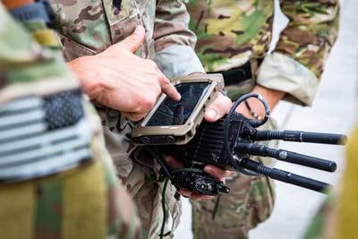 Soldiers from U.S. Army Special Operations Command train with connected devices in preparation for their employment during Project Convergence 22.