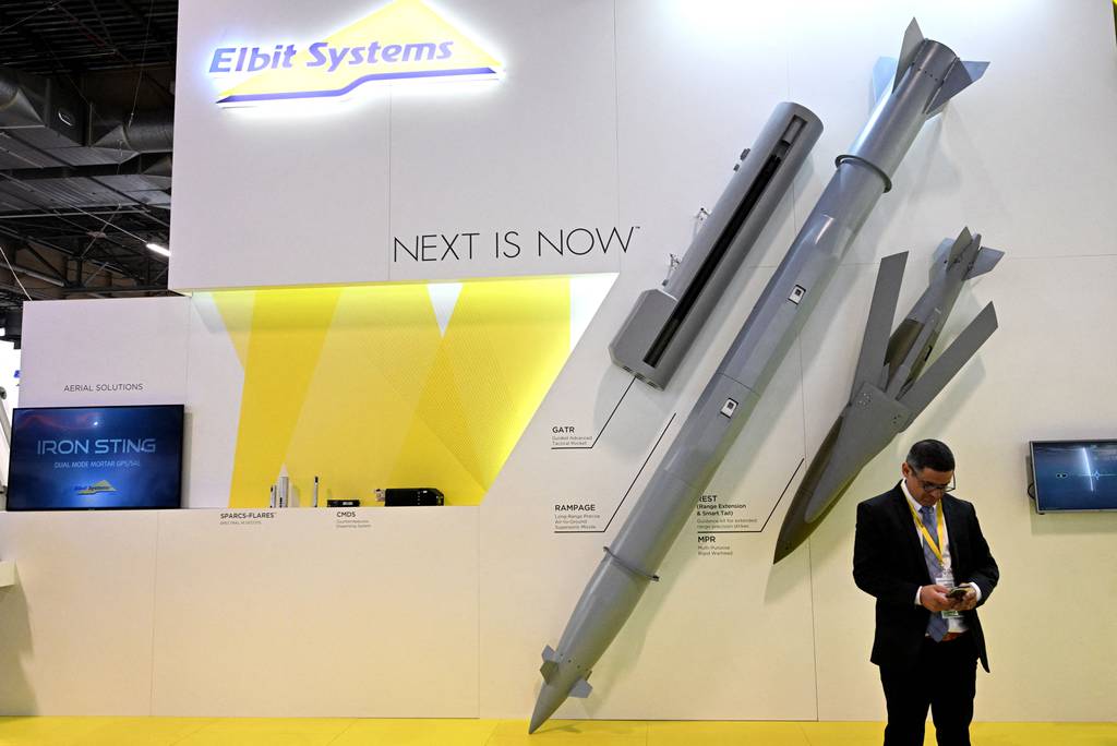 An Elbit Systems staff member looks at his phone during the Eurosatory international defense and security trade fair in France on June 13, 2022.