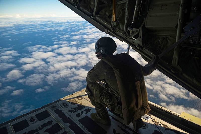Tech. Sgt. Alexander Lauher, 29th Weapons Squadron weapons instructor, looks out the back of a C-130J Hercules during a Green Flag-West 23-02 mission over the Pacific Ocean on Nov. 7, 2022. To modernize and strengthen the military for strategic competition, the 549th Combat Training Squadron used exercise Green Flag-West 23-02 to focus on facilitating air operations in maritime surface warfare missions. (Senior Airman Zachary Rufus/Air Force)