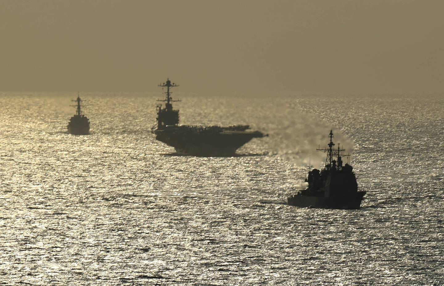 The Ticonderoga-class guided-missile cruiser USS Normandy (CG 60), front, the Nimitz-class aircraft carrier USS Harry S. Truman (CVN 75) and the Arleigh Burke-class guided-missile destroyer USS Lassen (DDG 82) transit the Atlantic Ocean on July 18, 2019.