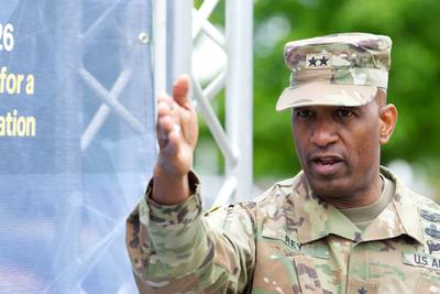 Maj. Gen. Jeth Rey, the director of the U.S. Army Network Cross-Functional Team, points at a tech exhibit at Fort Myer, Virginia, in May 2023. (Colin Demarest/C4ISRNET)