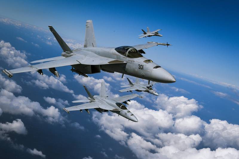 F/A-18E Super Hornets fly in formation March 12, 2019, during a photo exercise over California.
