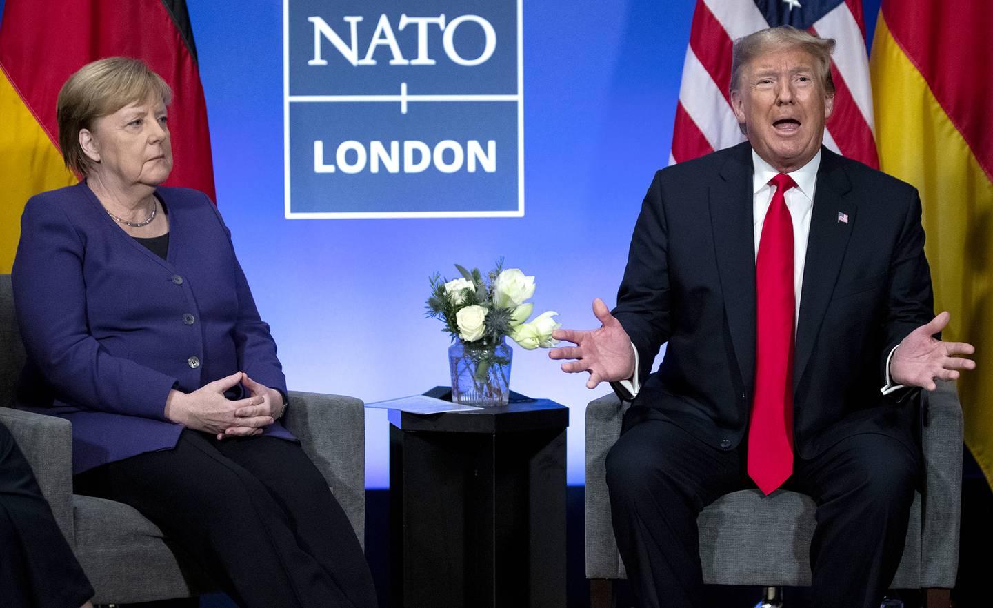 In this Dec. 4, 2019, file photo President Donald Trump meets with German Chancellor Angela Merkel during the NATO summit at The Grove in Watford, England