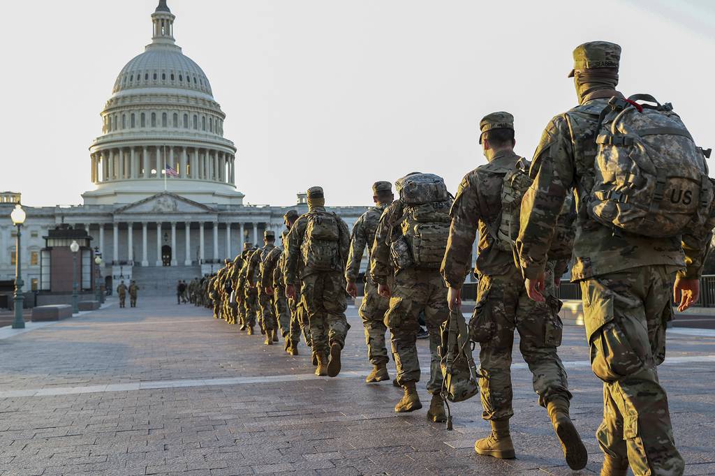 Members of the National Guard arrive at the U.S. Capitol on Jan. 12, 2021, in Washington.